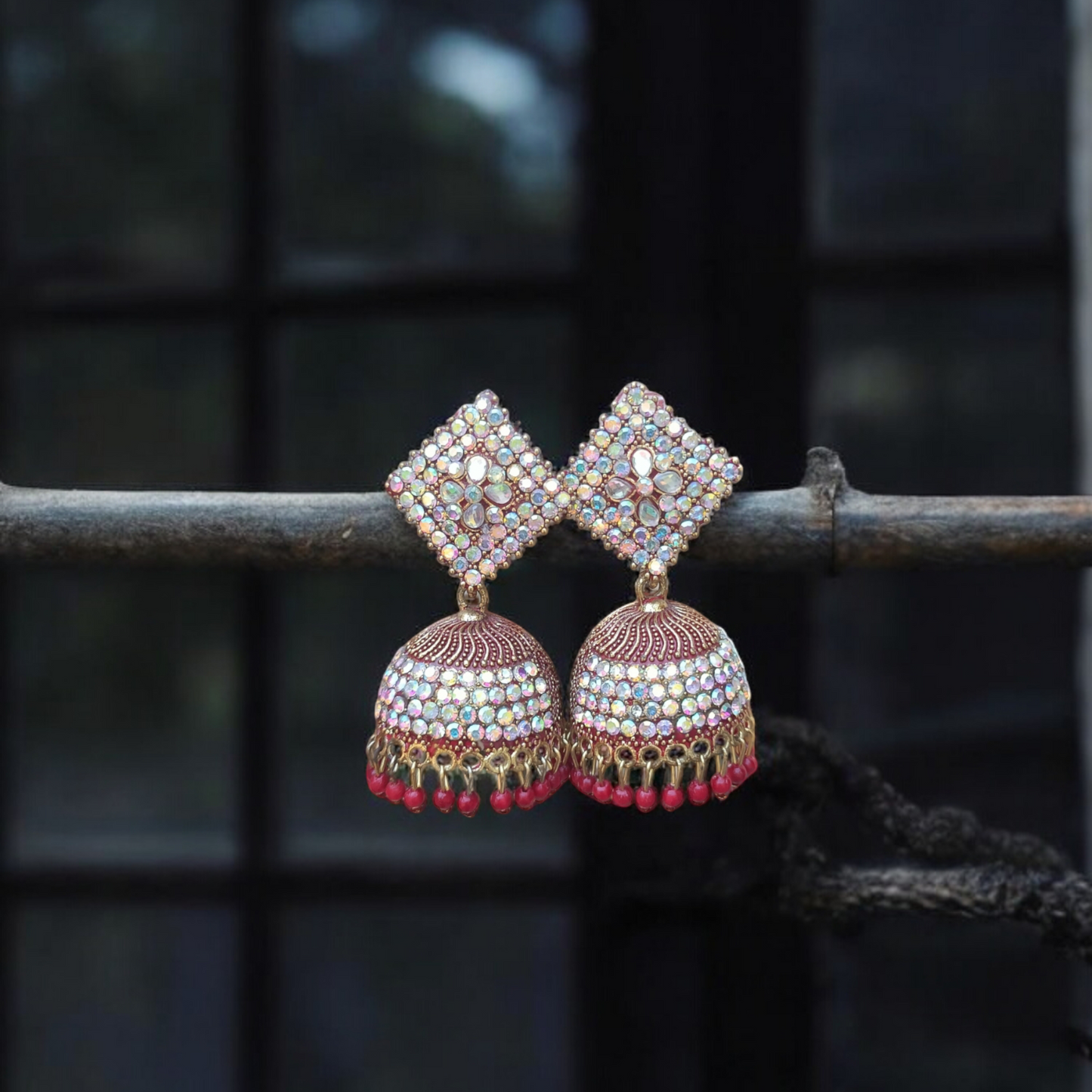 Traditional jhumkas with a blend of red and silver stone elegance.