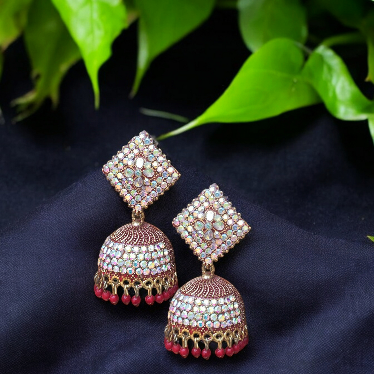 Traditional jhumkas with a blend of red and silver stone elegance.