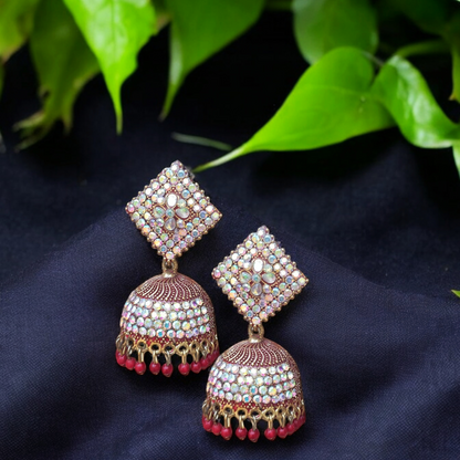 Traditional jhumkas with a blend of red and silver stone elegance.