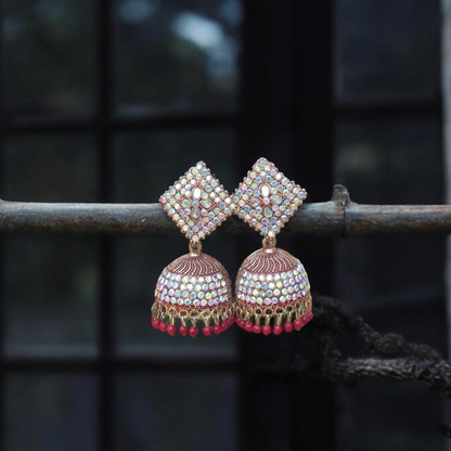 Traditional jhumkas with a blend of red and silver stone elegance.